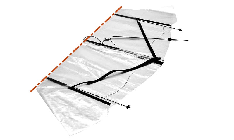 Kite disassembly step 4: the Dyneema sail folded, matching the factory fold.